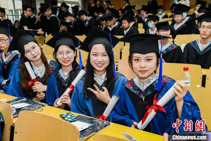 华东理工大学毕业生手持毕业纪念卷轴。　华东理工大学供图