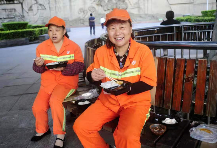 环卫工们正在吃志愿者送来的豆花饭（央广网发 涪陵区委宣传部供图）　