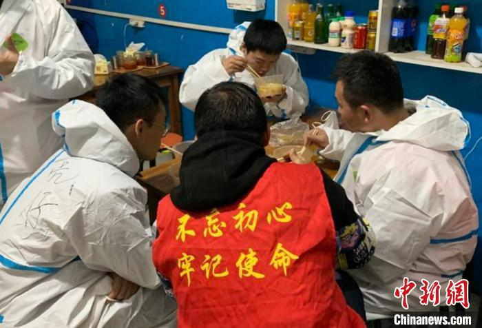 防疫人员在爱心店家吃着暖心牛肉面。　巩长青 摄