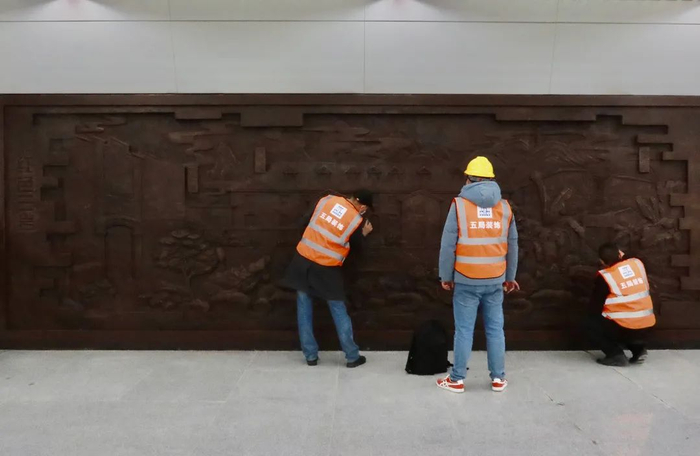 工作人员检查墙面浮雕 龚浩月 摄