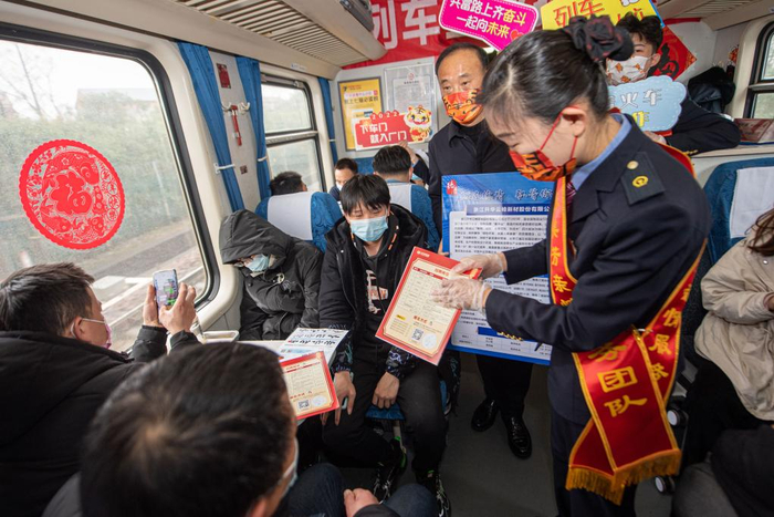 2月18日，列车员向旅客介绍企业招聘信息。新华社记者江汉摄