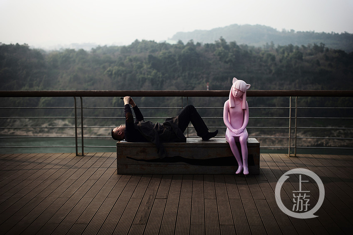 悦来粉色雕塑旁的躺平者。冉文 摄