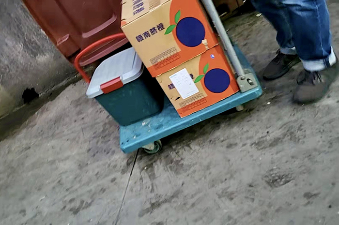 运维人员在倒垃圾，鲜果和干净组件被放置一侧。