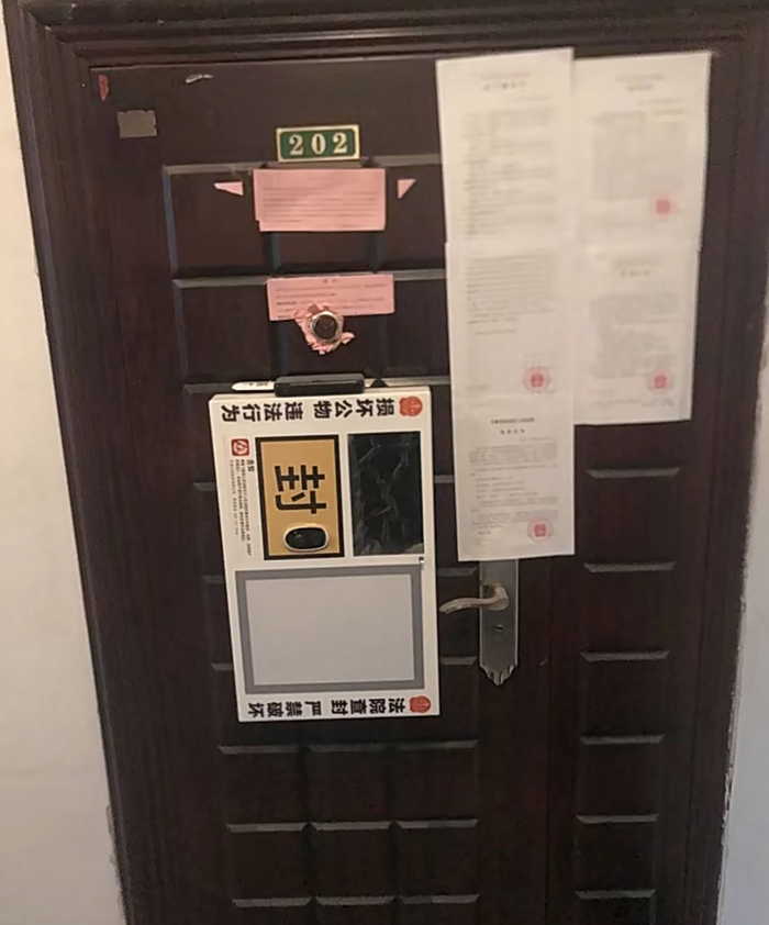 3月2日，广州市一套被执行的房产门外已张贴了数张法院公示。受访者供图