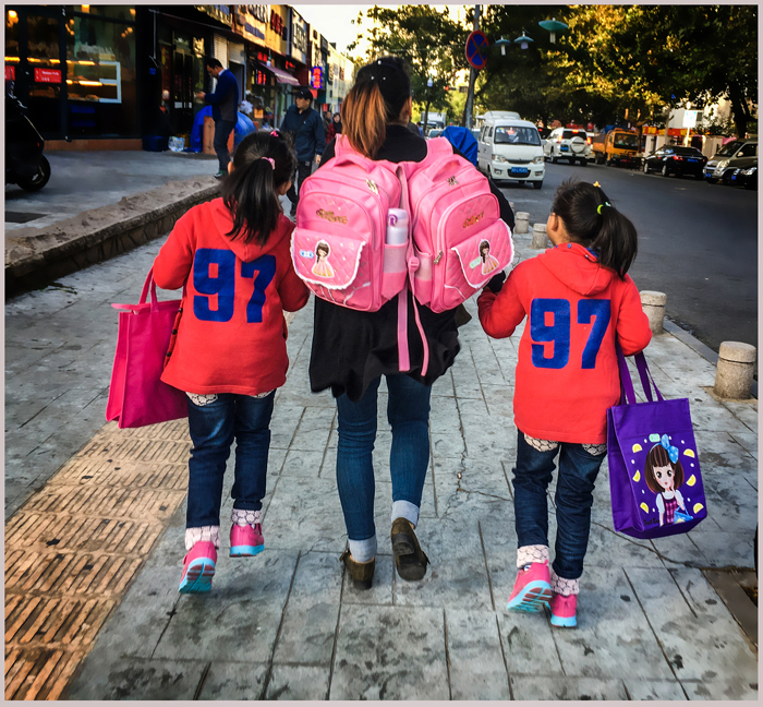 母亲送双胞胎孩子上学