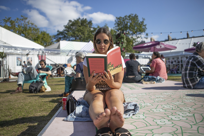 在2019 年爱丁堡国际图书节上，女孩在夏洛特广场花园的阳光下阅读。