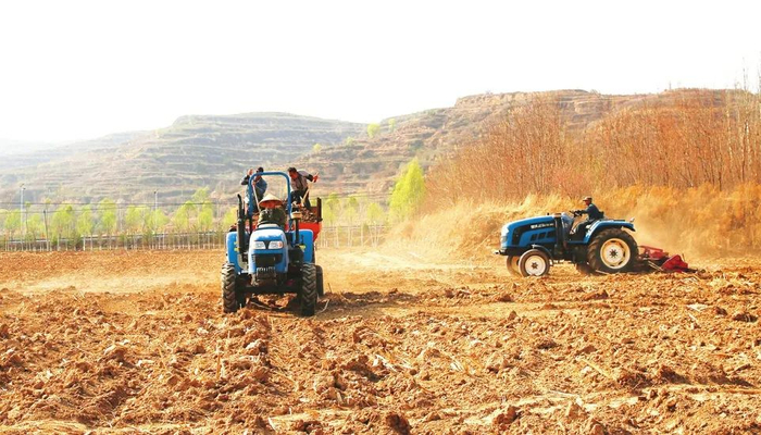 4月18日，方山县龙腾种养专业合作社社员驾驶机械正忙着撒肥、耕地。肖继旺/摄