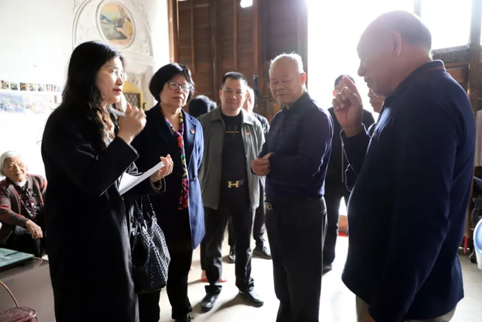 在“中宪第”仙湖里，杨仁梅的侄儿杨烈章（右一）向记者介绍家族的历史。陈丽冰 摄