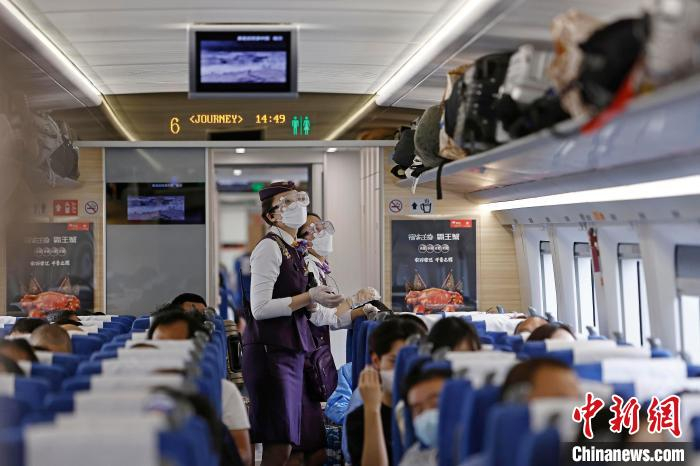 列车长沈乔对车厢进行安全检查。　殷立勤 摄