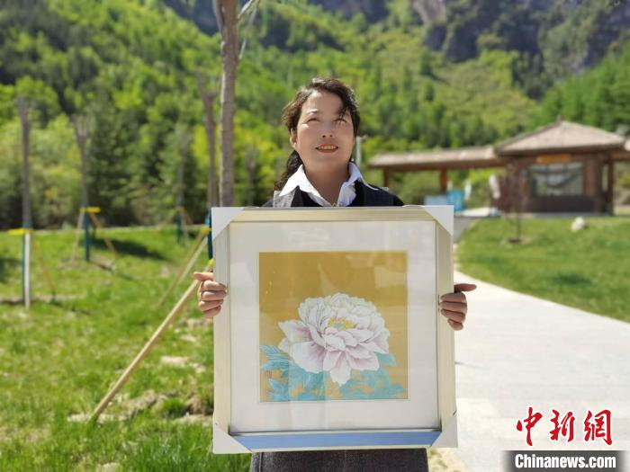 图为漳县盐画创作艺人汪航展示自己用盐创作的《牡丹》。　张婧 摄