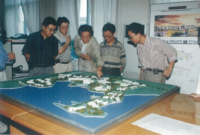 图为：袁培煌（居中）和后辈建筑师讨论项目方案。