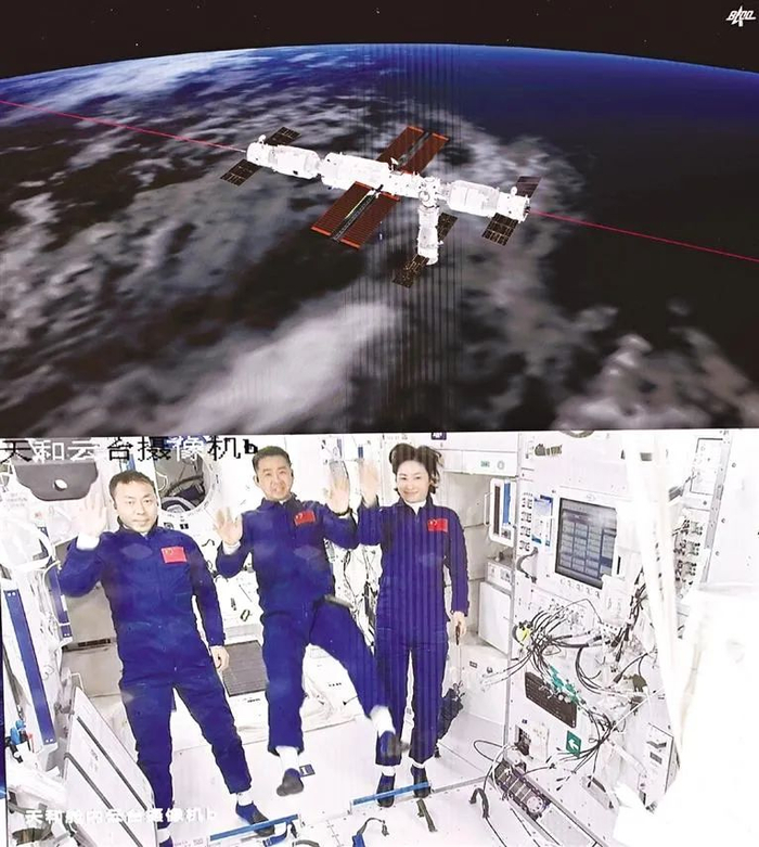 6月5日在北京航天飞行控制中心拍摄的进驻天和核心舱的航天员陈冬（中）、刘洋（右）、蔡旭哲向全国人民挥手致意的画面。