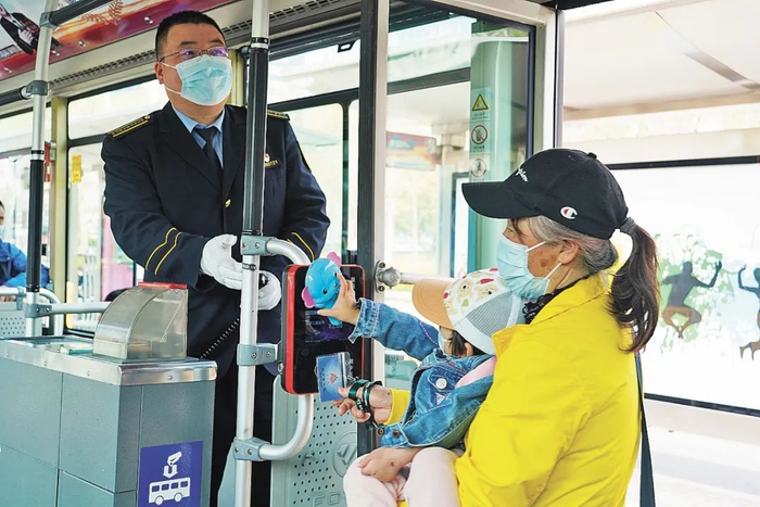  4月初，387路的乘务员张鹊鸣为上车乘客找座位。中青报·中青网记者 魏 晞/摄