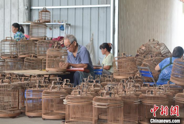 基地内，村民各司其职，共同完成鸟笼制作。　麦媛媛 摄