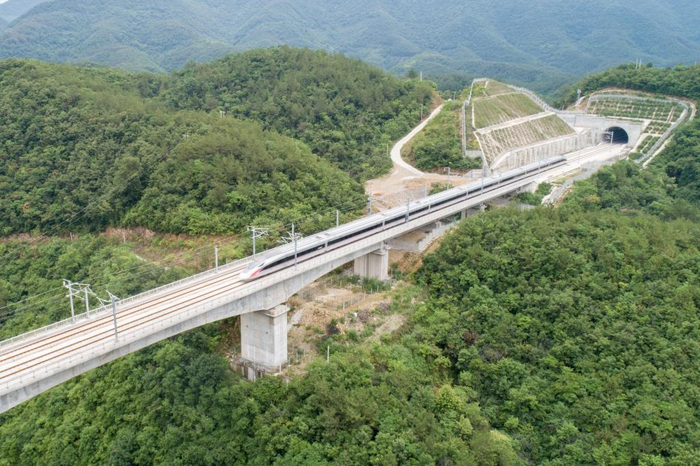 　　6月20日，郑渝高铁上的列车穿行在群山之间。新华社发 伍志尊摄
