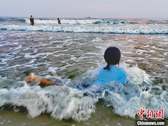 一孩童在水中戏耍。　翟李强 摄