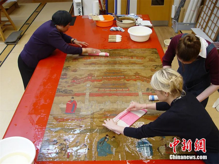 邱锦仙正与徒弟一起洗画。大英博物馆托管会供图 