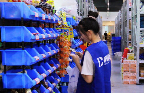 ▲“哆鲸选”店员正在仓内拣货