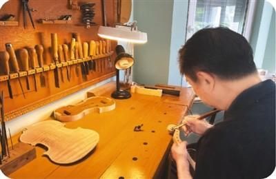 提琴制作师郑荃正在雕刻琴头。 本报记者 赵 昊摄