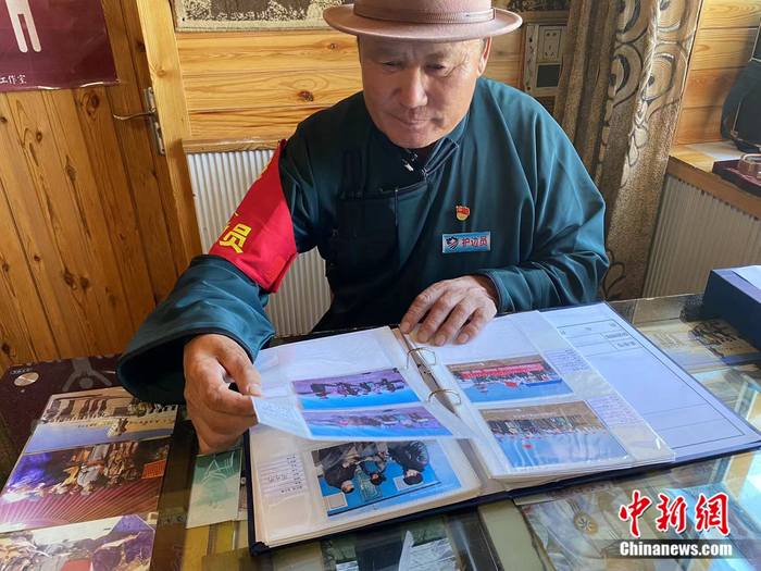 图门翻阅相册。苏亦瑜 摄