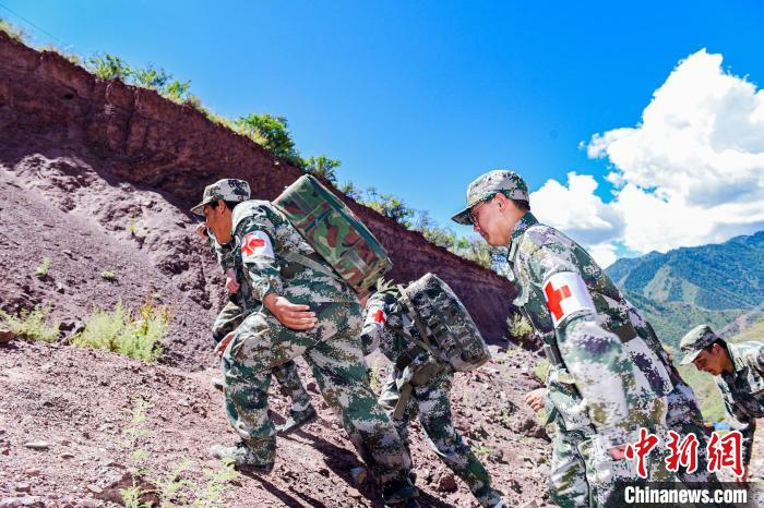 图为受训民兵在模拟自然灾害条件下进行搜救民众行动。　彭毅 摄