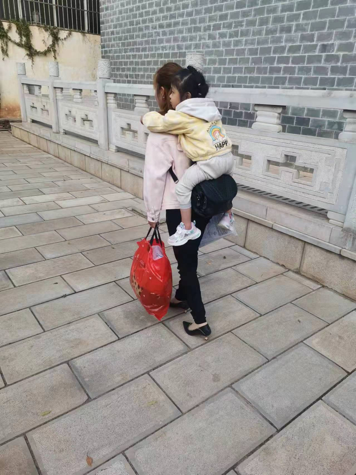 张静背着馨馨。