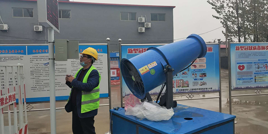     山东一工地，工人在调试降尘设备并采集数据回传至系统。受访者供图