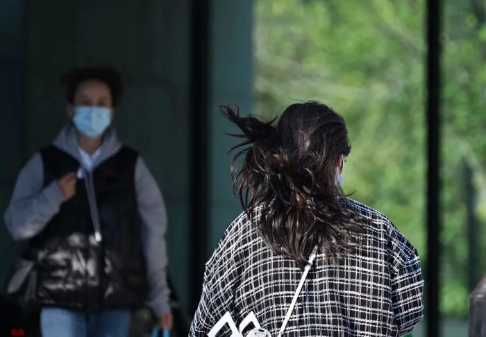 ▲豆各庄，路人的头发被大风吹起。