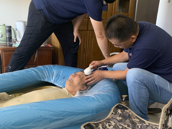 　助浴师正在为老人洗头。 受访者 供图