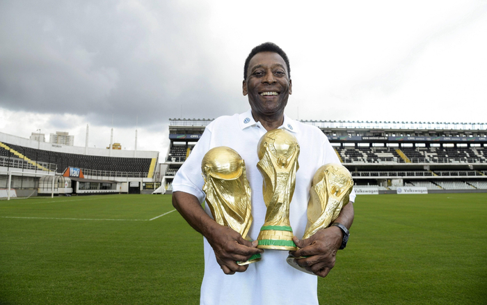 贝利和三座世界杯冠军奖杯合影。  资料图/视觉中国