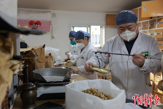     1月3日，北京市朝阳区六里屯社区卫生服务中心，中药房的药师在配药。中青报·中青网记者 曲俊燕/摄