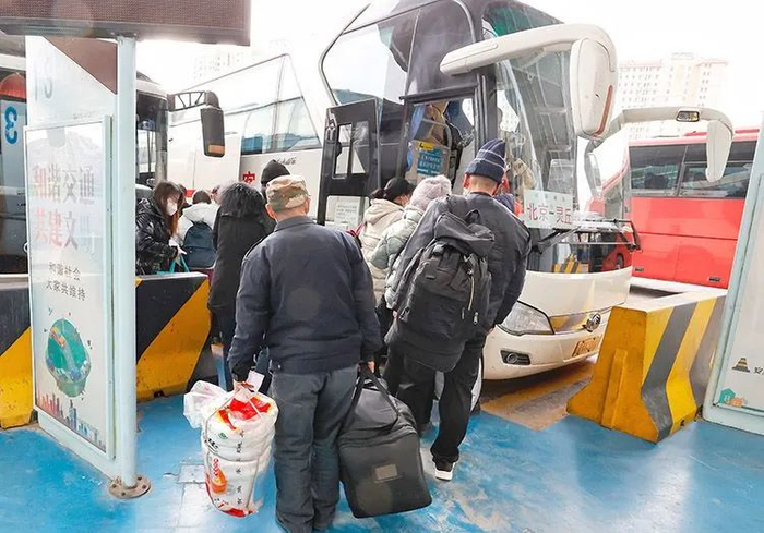 ▲旅客拎着行李，准备登上北京开往灵丘的长途客车。