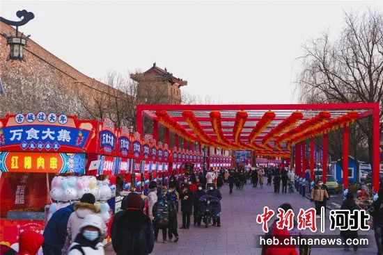 图为游客在山海关古城万食大集品美食。  孙航 摄 