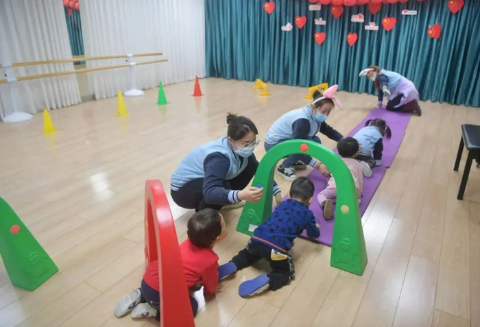 ▲北京托班试点金融街惠泽幼儿园（鼓楼园），老师带孩子们参加体育活动。新京报记者 李木易 摄