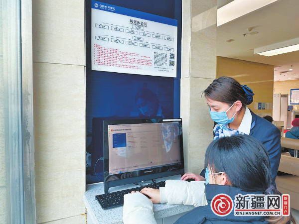 昨日，在乌鲁木齐银行和平北路支行，大堂经理庄轩（右）正在为客户指导代办营业执照。（全媒体记者王璇摄）