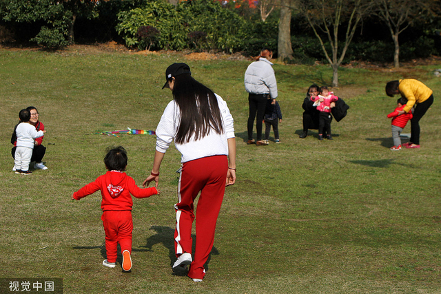 妈妈们带着各自的宝宝来到户外晒太阳。人民视觉 资料图