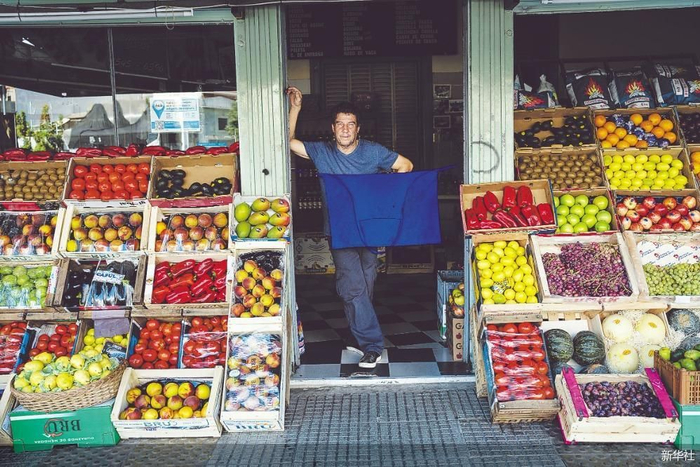 14日，在阿根廷布宜诺斯艾利斯，一名商贩在农贸市场等待顾客。