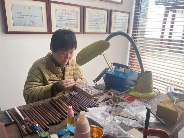 陆小琴在创作核雕。受访者供图