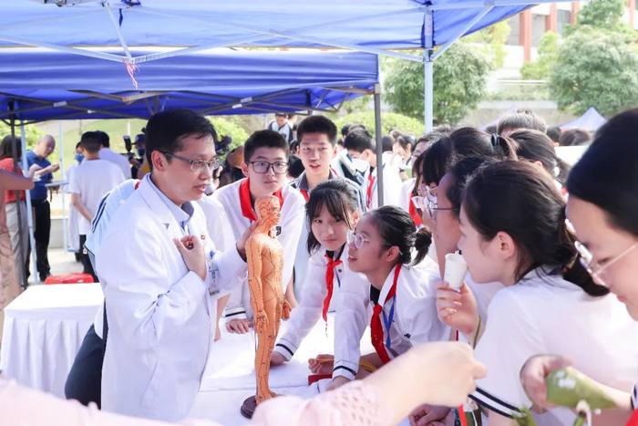 同学们在向中医专家学习人体经络穴位知识