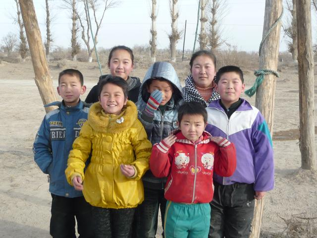 煌辉村的孩子们最后一次在村里的秋千下合影。王文明 摄