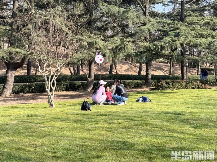 市民在绿道旁的草坪上露营