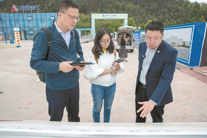     成都日报锦观新闻记者杨富（左）、吴喆（中）在宜宾成宜国际物流园采访