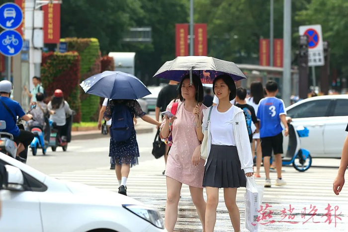 高温天气，石家庄出行的市民手拿冷饮，身穿防晒服、头戴遮阳帽来抵挡阳光。 燕赵晚报记者 张海强 摄 