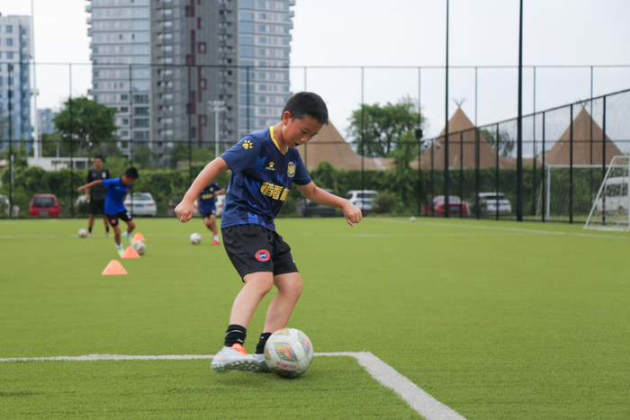 　　7月21日，在四川天府新区CDT运动公园内，小朋友参加暑期少儿足球训练。新华社记者 杨进 摄