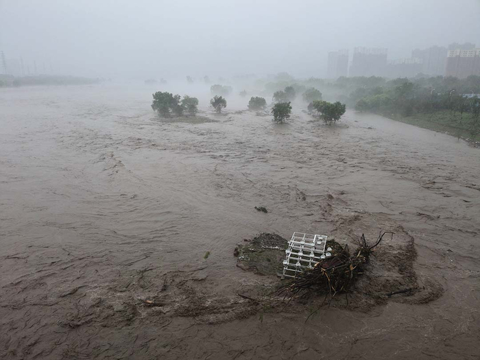 2023年8月1日，北京永定河泄洪，树枝等杂物被洪水席卷，景观灯被洪水淹没。