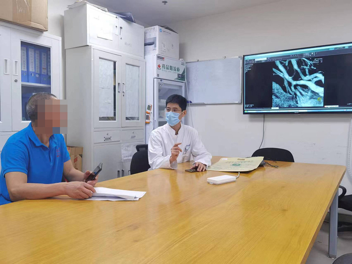 2023年8月18日，赵开军和一名河南患者术前谈话。受访者 供图