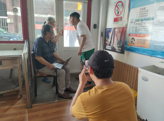 ▲陈卓和朋友正在帮老人们拍视频。新京报记者 郭懿萌 摄