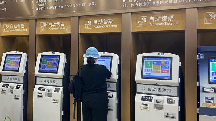 2023年9月13日,北京, 北京站售票大厅,旅客使用自助售票机购买车票.