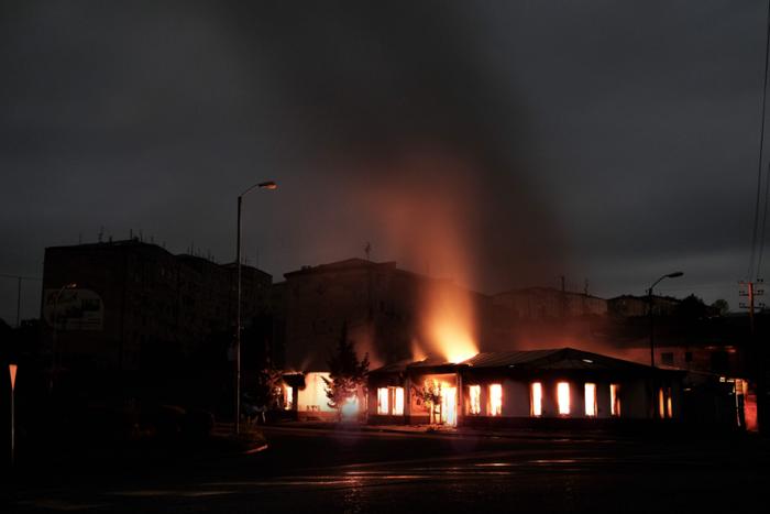 ▲资料图片：纳卡地区首府斯捷潘纳克特一处建筑遭到炮击后燃烧。图源：外媒