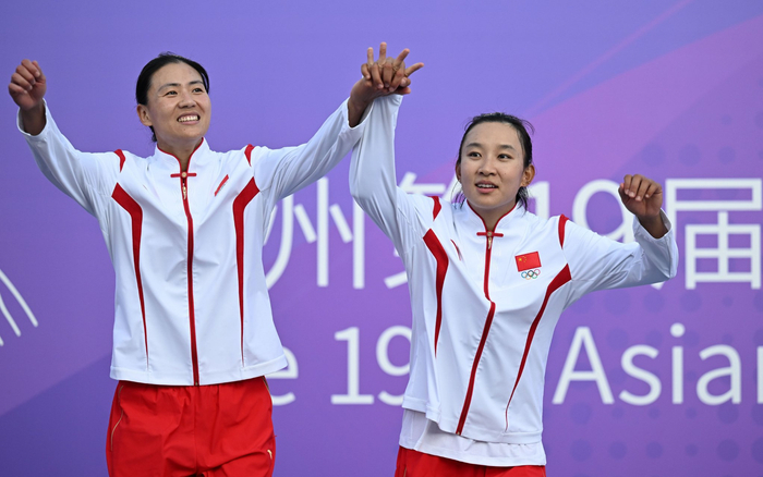 身高1.91米的薛晨（左）搭档夏欣怡摘下亚运会女子沙排金牌。  图/新华社